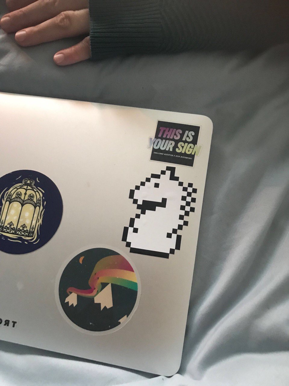 A laptop with multiple stickers, including one of the knight